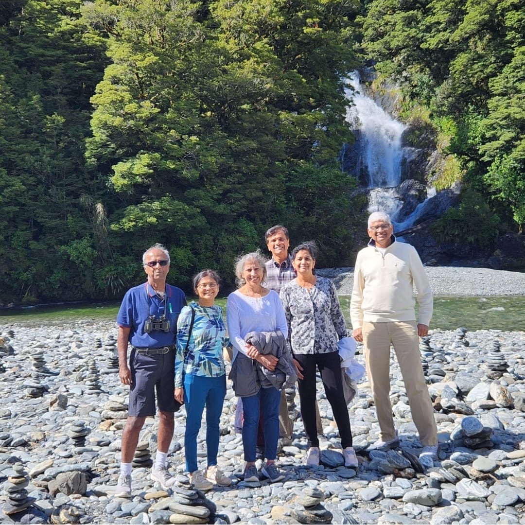 Group of travellers at a New Zealand waterfall